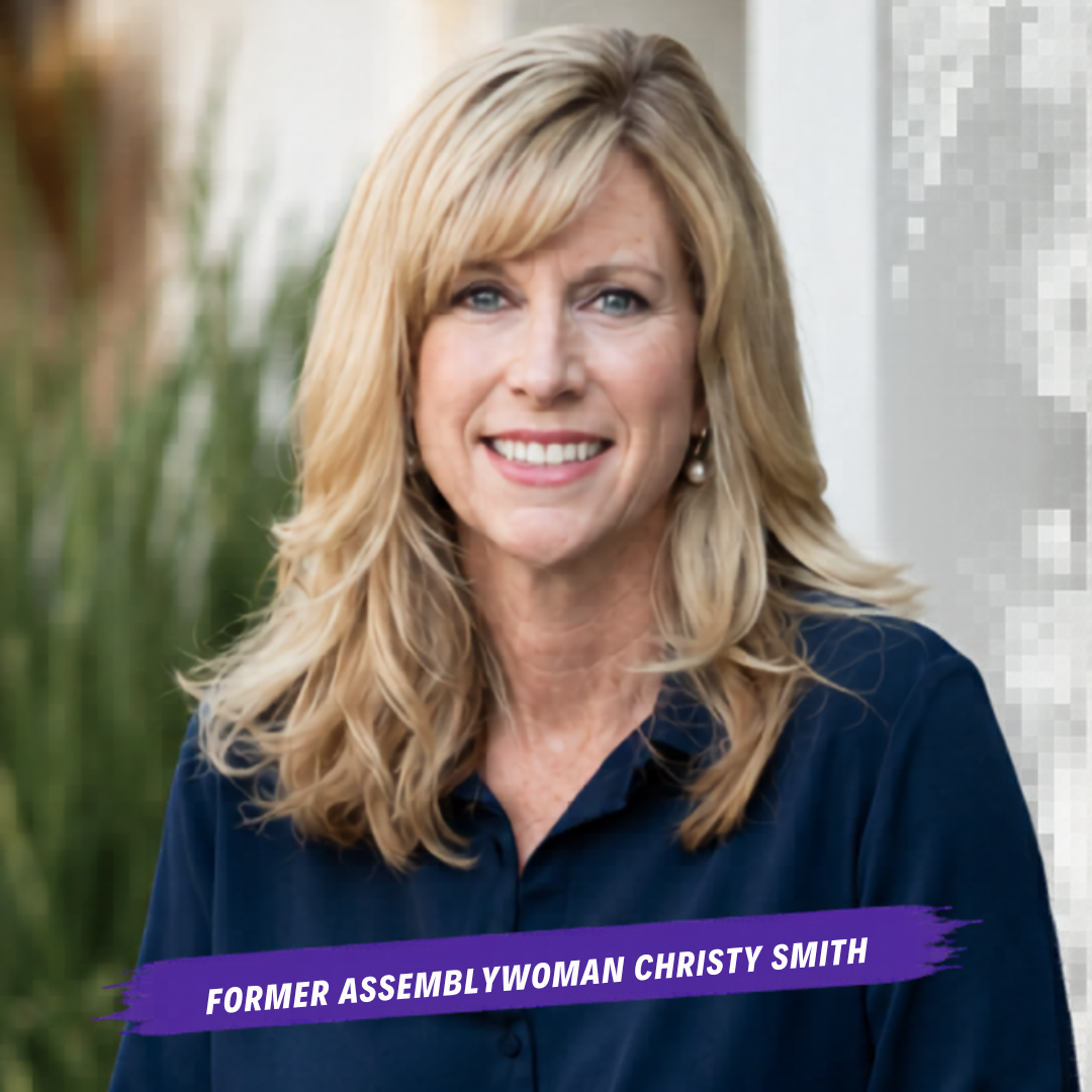 headshot of former assemblywoman christy smith, long blond hair wearing black collared shirt standing in front of a white building and green landscaping